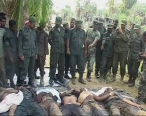 Video grab shows soldiers standing near bodies