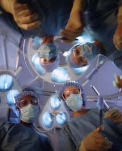 Looking upwards at faces of surgeons