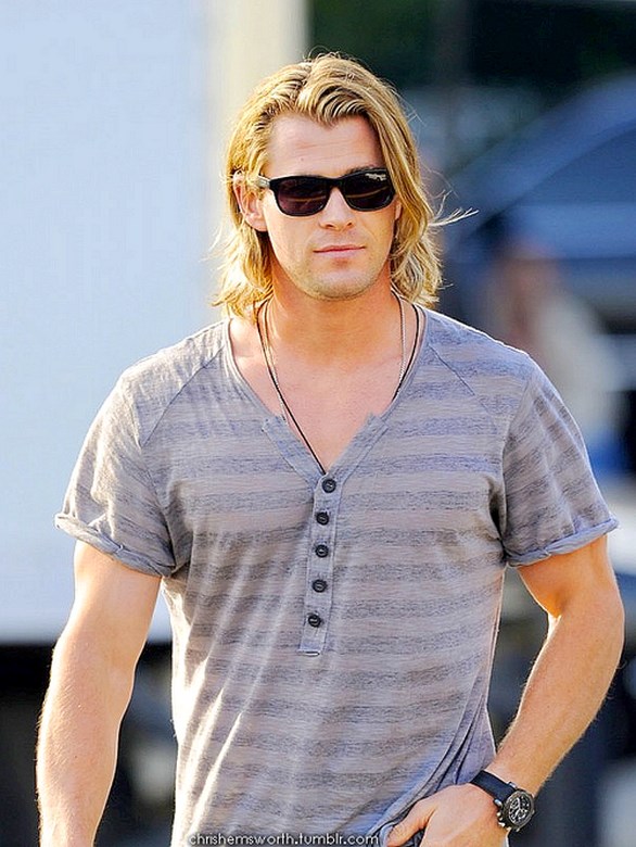 Chris Hemsworth shows off his ripped body as he chills by his hotel pool.