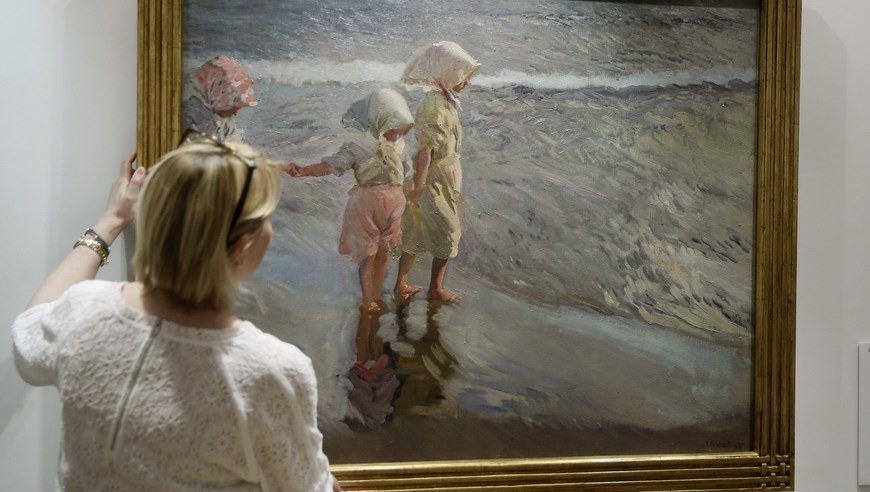 GRA610. MADRID, 08/05/2015.- Alexandra McMorrow, jefe de la pintura del siglo XIX de Christie's a nivel mundial, muestra el cuadro "Las tres hermanas en la playa" de Sorolla, que se exhibirá en la Sala Christie's de Madrid del 11 al 14 de mayo, antes de su subasta el próximo 15 de junio en Londres. EFE/Fernando Alvarado