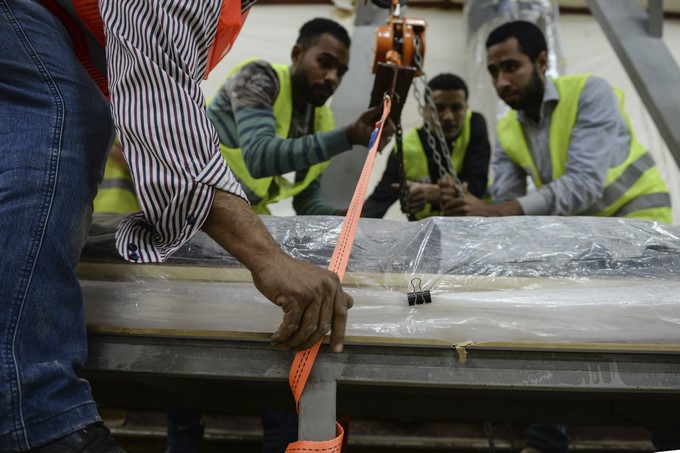 Arquéologos levantan una pieza de madera de 26 metros de la segunda barca funeraria de Keops antes de su restauración en Guiza (Egipto) hoy. EFE/