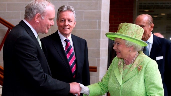 La reina Isabel II de Inglaterra saluda al ex comandate del IRA, el ahora viceministro principal norirlandés Martin McGuinness (izq), junto al ministro principal de Irlanda del Norte Peter Robinson (2º izq), en Belfast, Reino Unido. EFE/Archivo