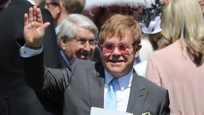 British musician Sir Elton John waves to the crowd as he leaves after the royal wedding ceremony of Prince Harry and Meghan Markle at St George's Chapel in Windsor Castle, in Windsor, Britain, 19 May 2018. EFE