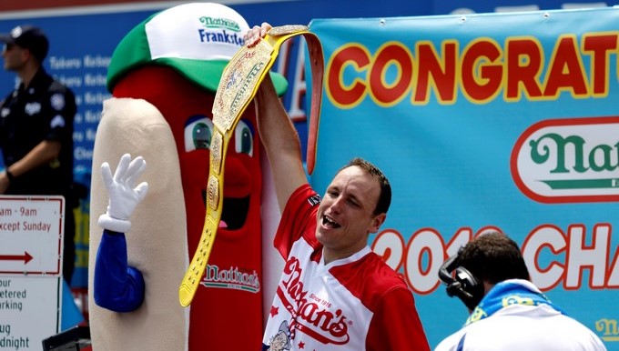 El estadounidense Joey Chestnut (c) participa en un concurso de comer perritos calientes en Nueva York (Estados Unidos) hoy, 4 de julio del 2018, durante las celebraciones de la independencia del país. EFE