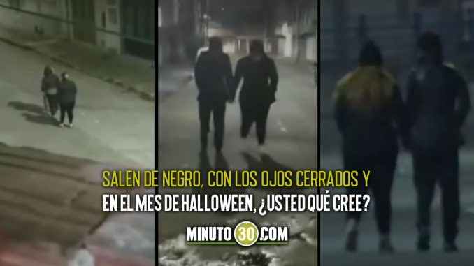 En un barrio personas caminan hacia atrás a las 12 p.m. En un barrio personas caminan hacia atrás a las 12 p.m.