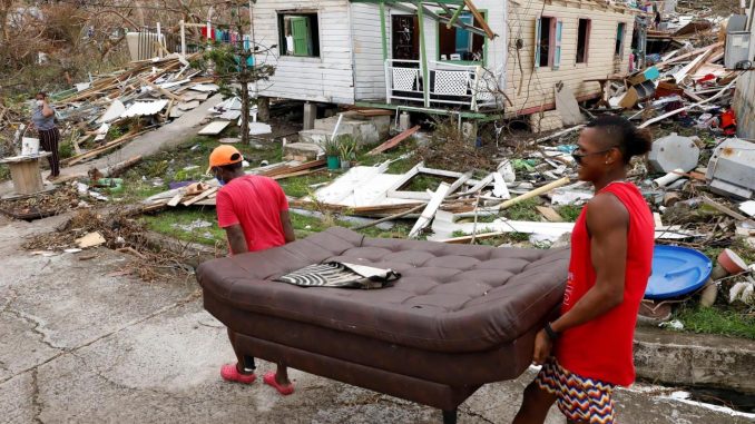 Fotografía de archivo del 21 de noviembre de 2020 que muestra a dos hombres mientras cargan un sofá frente a una casa destruida en medio de los escombros que dejó el paso del huracán Iota, en la isla de Providencia, Archipiélago de San Andrés (Colombia). EFE/ Mauricio Dueñas Castañeda cambio climático