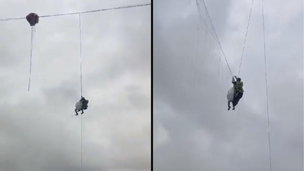 Quedaron colgando un parapentista y niña en un cable de tensión