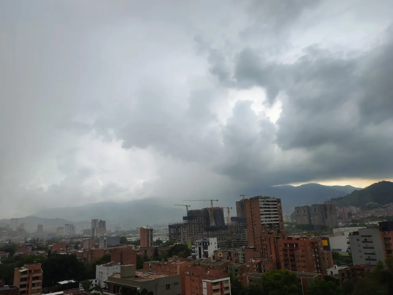 Aguacero en el Valle de Aburrá: SIATA reporta 27 descargas eléctricas en 30 minutos y lluvia de Caldas a Bello 3 Cielo cubierto y lluvia sobre edificios del Valle de Aburrá este domingo.